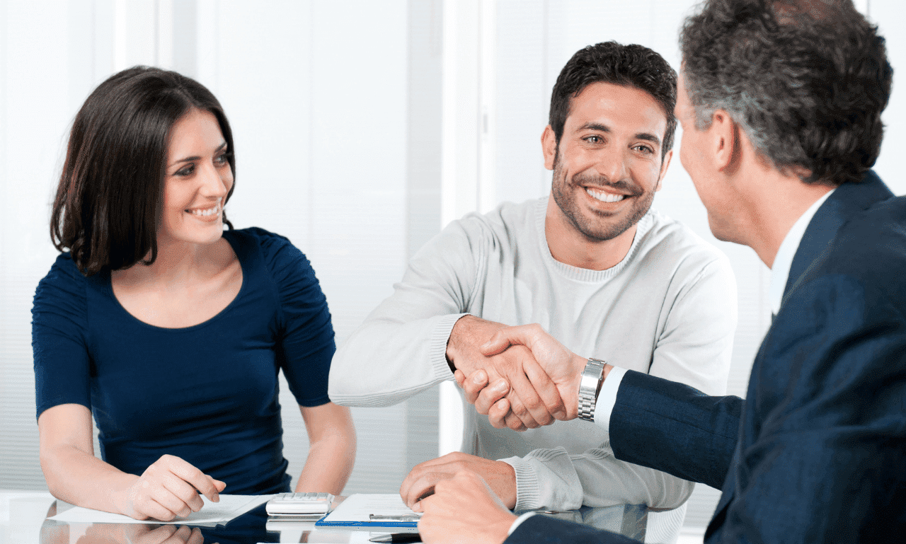 Professional meeting between a financial planner and clients, symbolizing personal finance planning and financial success.