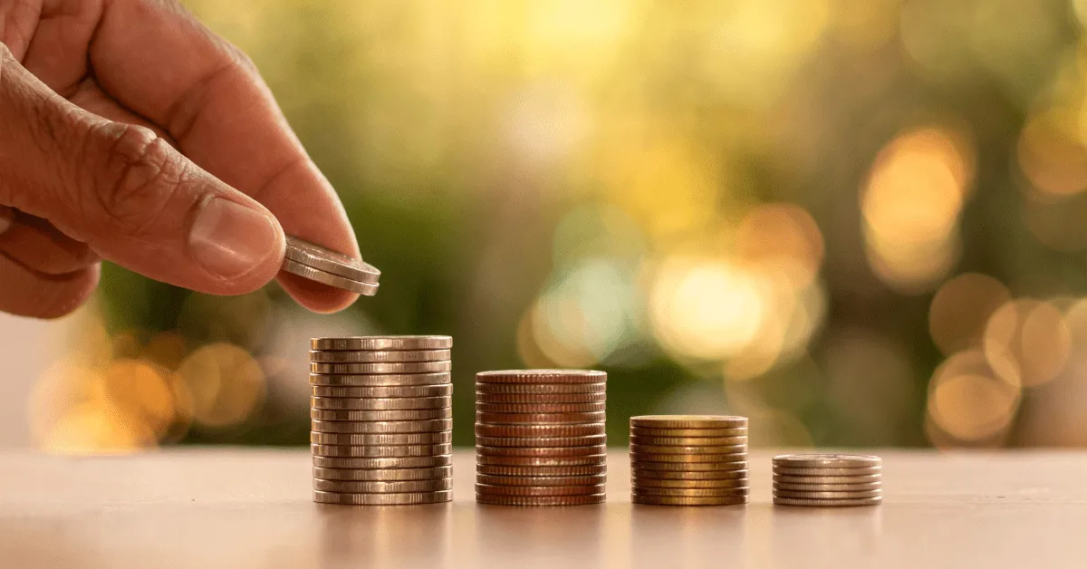 Stacking coins to represent building wealth and financial abundance.
